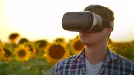 Un-Joven-Inspecciona-Un-Campo-Con-Girasoles-Con-Gafas-De-Realidad-Virtual-En-Un-Día-Soleado.-Estas-Son-Tecnologías-Modernas-En-Las-Noches-De-Verano.